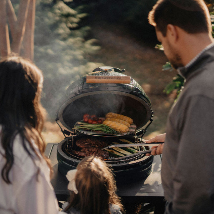 Family grilling on Big Green Egg