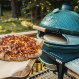 pizza going into grill